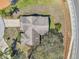Aerial view of the home showcasing the roof, surrounding trees, and ample driveway space at 8137 Greenside Ln, Hudson, FL 34667
