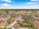An aerial view showcases the neighborhood homes, mature trees, and surrounding community at 8137 Greenside Ln, Hudson, FL 34667