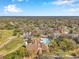 A close aerial shot of a community center featuring a pool, tennis courts, and golf course at 8137 Greenside Ln, Hudson, FL 34667