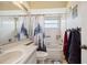 Compact bathroom with a vanity sink, tub with shower, and decorative shower curtain at 8137 Greenside Ln, Hudson, FL 34667