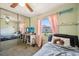 Cozy bedroom with large mirrored closet doors, ceiling fan, and pink curtains at 8137 Greenside Ln, Hudson, FL 34667