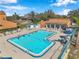 Inviting community pool with crystal-clear water, ample lounge chairs, and a shaded pavilion at 8137 Greenside Ln, Hudson, FL 34667