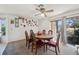 Cozy dining room with a classic wooden table and chairs, brightened by natural light from a large window at 8137 Greenside Ln, Hudson, FL 34667
