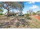 Inviting single-story home with a well-maintained lawn and mature trees, exuding curb appeal at 8137 Greenside Ln, Hudson, FL 34667