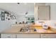 The kitchen features a stainless steel sink, white cabinets, and a view to the dining room at 8137 Greenside Ln, Hudson, FL 34667