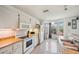 Bright kitchen featuring white cabinets and appliances, with ample counter space and a window overlooking the yard at 8137 Greenside Ln, Hudson, FL 34667