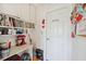 The mud room has a laundry room door, storage shelf and cabinet, red mixer, and convenient accessories at 8137 Greenside Ln, Hudson, FL 34667