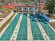 Overhead view of shuffleboard courts with a covered pavilion and manicured landscaping at 8137 Greenside Ln, Hudson, FL 34667