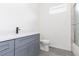 Bathroom with gray vanity, quartz countertop, and a toilet at 9510 Xenia St, New Port Richey, FL 34654