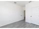 Unfurnished bedroom with LVP flooring, white trim, and white walls at 9510 Xenia St, New Port Richey, FL 34654