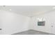 This bedroom features neutral paint, recessed lighting, modern gray flooring, and a window at 9510 Xenia St, New Port Richey, FL 34654
