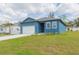 Blue single-story home featuring a garage, front lawn, and blue paint color at 9510 Xenia St, New Port Richey, FL 34654