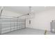 Spacious garage with modern door, epoxy flooring, and a tank water heater at 9510 Xenia St, New Port Richey, FL 34654