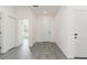 Hallway boasts light gray flooring, white doors and trim, and white walls at 9510 Xenia St, New Port Richey, FL 34654