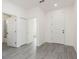 Bright hallway featuring doors, light gray flooring, and white paint at 9510 Xenia St, New Port Richey, FL 34654