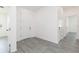 Hallway boasts light gray flooring, white doors and trim, and white walls at 9510 Xenia St, New Port Richey, FL 34654