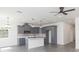 Modern kitchen with gray cabinetry, white backsplash, an island, and stainless appliances at 9510 Xenia St, New Port Richey, FL 34654