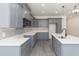 Kitchen with gray cabinets, subway tile backsplash, white countertops, and modern lighting at 9510 Xenia St, New Port Richey, FL 34654