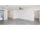 Spacious living room with white walls and gray flooring at 9510 Xenia St, New Port Richey, FL 34654