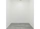 Small room showcasing its gray wood-look flooring, crisp white walls, and empty space at 9510 Xenia St, New Port Richey, FL 34654