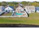 Aerial view of backyard pool, patio, and white fence, situated between neighboring homes at 10610 Lakeside Vista Dr, Riverview, FL 33569