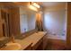 Bathroom featuring double sinks, a large mirror, and a shower-tub combination at 11019 Connacht Way, Tampa, FL 33610
