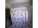 Small bathroom featuring a vanity, toilet, and a floral patterned shower curtain at 11019 Connacht Way, Tampa, FL 33610