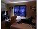 Bedroom with cozy armchair, natural light from window, and space for relaxation at 11019 Connacht Way, Tampa, FL 33610