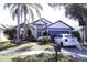 Charming single-Gathering home with a well-maintained lawn, palm tree, and a two-car garage at 11019 Connacht Way, Tampa, FL 33610