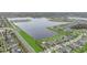 Expansive aerial view showcasing a community bordered by a lake and lush green spaces at 11330 Lake Lucaya Dr, Riverview, FL 33579