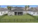 Aerial view of a fenced backyard featuring a screened patio and green lawn at 11330 Lake Lucaya Dr, Riverview, FL 33579