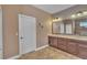 Double vanities with a large mirror in the main bathroom at 11330 Lake Lucaya Dr, Riverview, FL 33579