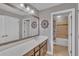 Well-lit bathroom featuring a large mirror, double sinks, and tiled floors at 11330 Lake Lucaya Dr, Riverview, FL 33579