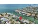 Stunning aerial view of waterfront home with boat dock in a desirable coastal community at 116 9Th E St, Tierra Verde, FL 33715