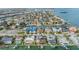 An aerial view captures a vibrant waterfront community with homes nestled along canals, showcasing the beauty of waterfront living at 116 9Th E St, Tierra Verde, FL 33715