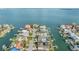 Panoramic aerial view of an island community with homes lining the canal with private boat docks on the intercoastal at 116 9Th E St, Tierra Verde, FL 33715