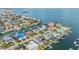 Aerial view of a coastal neighborhood with homes along canals, each with a boat dock and ocean access at 116 9Th E St, Tierra Verde, FL 33715