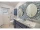 Bathroom with modern double sinks and a tiled wall feature at 116 9Th E St, Tierra Verde, FL 33715