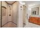 Bathroom featuring tiled shower and vanity with granite countertop and warm lighting at 116 9Th E St, Tierra Verde, FL 33715