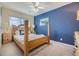Comfortable bedroom featuring a blue accent wall and natural light at 116 9Th E St, Tierra Verde, FL 33715
