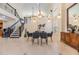 Dining area with a modern table set, chandelier, and staircase in an open layout home at 116 9Th E St, Tierra Verde, FL 33715