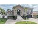 Charming two-story home with grand staircase leading to an elegant double door entrance at 116 9Th E St, Tierra Verde, FL 33715