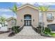 Inviting two-story home featuring a grand staircase, lush landscaping, and an attached garage at 116 9Th E St, Tierra Verde, FL 33715