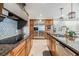 Modern kitchen featuring granite countertops, stainless appliances, wood cabinets, and backsplash at 116 9Th E St, Tierra Verde, FL 33715