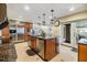 A bright kitchen with granite counters, stainless steel appliances, island, and french doors at 116 9Th E St, Tierra Verde, FL 33715