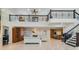 Bright, open living space with high ceilings, a fireplace, and staircase with iron banisters at 116 9Th E St, Tierra Verde, FL 33715