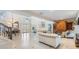 Spacious living room with high ceilings, tiled floors, and elegant staircase at 116 9Th E St, Tierra Verde, FL 33715