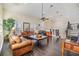 Open-concept living area with hardwood floors, large windows, and comfortable sofas, ideal for entertaining at 116 9Th E St, Tierra Verde, FL 33715