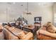 Spacious living room features vaulted ceilings, hardwood floors, a staircase, and comfortable leather sofas at 116 9Th E St, Tierra Verde, FL 33715