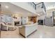 An open concept living room with fireplace, staircase, and view to kitchen at 116 9Th E St, Tierra Verde, FL 33715